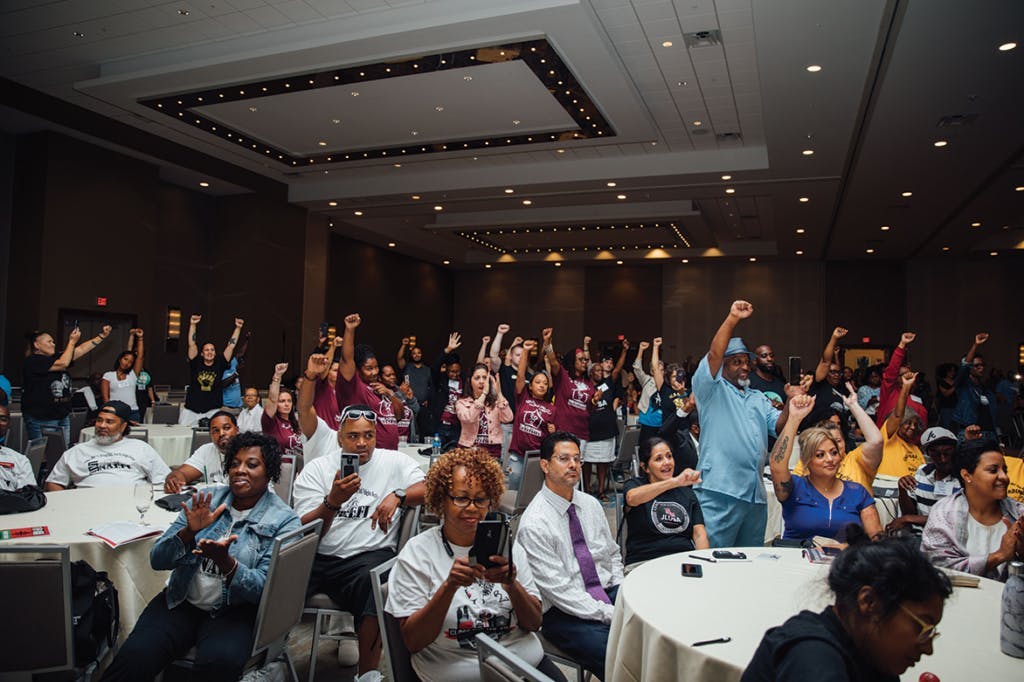 people cheering at an event for Formerly Incarcerated and Convicted People and Families Movement