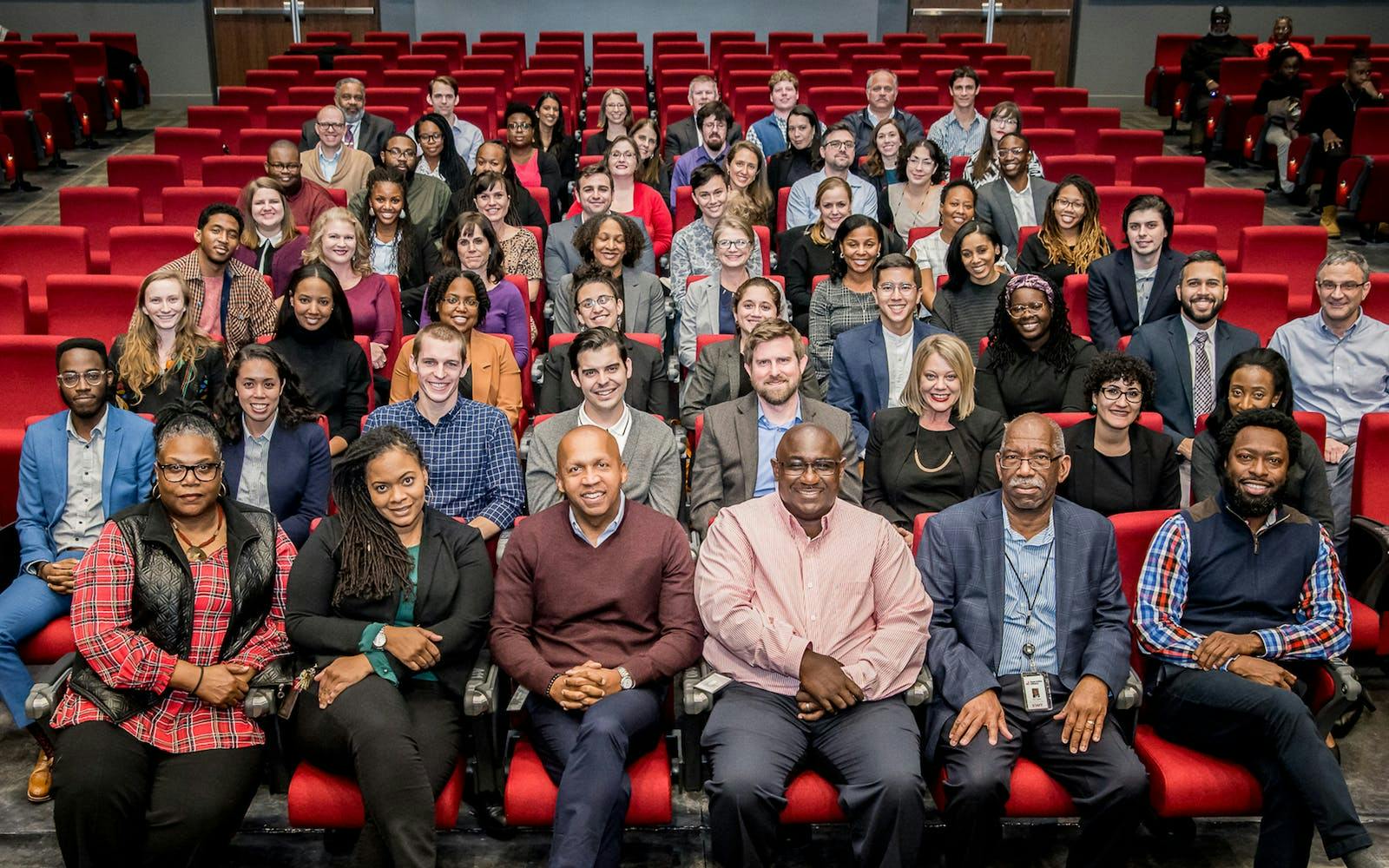 group of people that work with the Equal Justice Initiative sitting in a theater